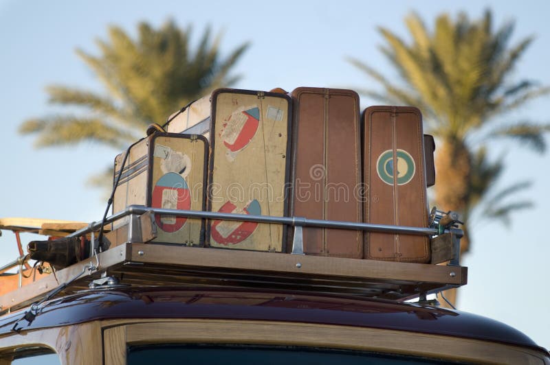 Vintage wood car with old travel suitcases