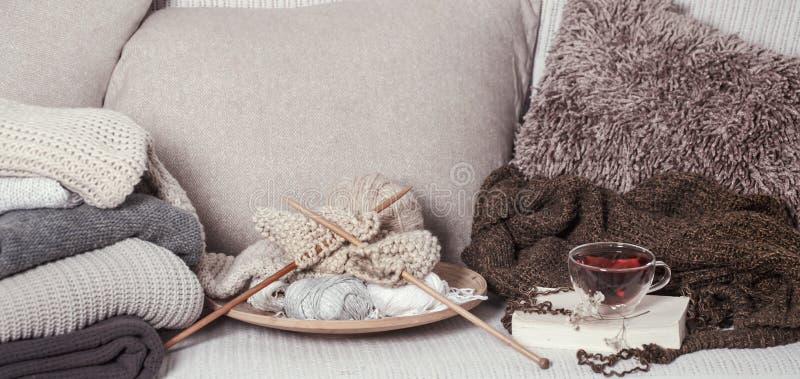 Vintage wooden knitting needles and threads for knitting on a cozy