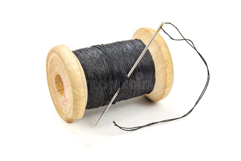 Spool Of Black Thread On White Shirt With Needle, Needle Is