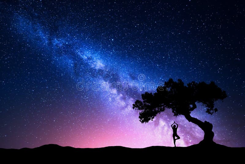 Milky Way with old tree and silhouette of a standing woman practicing yoga. Beautiful landscape with meditating girl under the tree against starry sky with pink milky way. Amazing galaxy. Universe. Milky Way with old tree and silhouette of a standing woman practicing yoga. Beautiful landscape with meditating girl under the tree against starry sky with pink milky way. Amazing galaxy. Universe