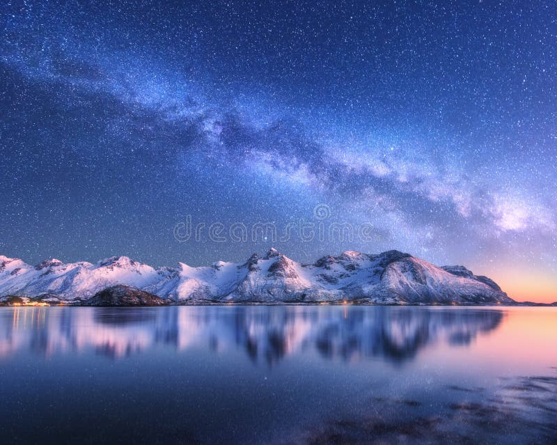 Bright Milky Way over snow covered mountains and sea at night in winter in Norway. Landscape with snowy rocks, starry sky, reflection in water, fjord. Lofoten Islands. Space. Beautiful milky way. Bright Milky Way over snow covered mountains and sea at night in winter in Norway. Landscape with snowy rocks, starry sky, reflection in water, fjord. Lofoten Islands. Space. Beautiful milky way