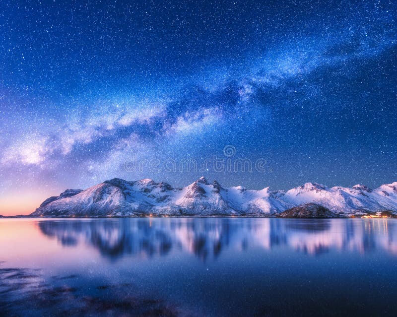 Bright Milky Way over snow covered mountains and sea at night in winter in Norway. Landscape with snowy rocks, starry sky, reflection in water, fjord. Lofoten Islands. Space. Beautiful milky way. Bright Milky Way over snow covered mountains and sea at night in winter in Norway. Landscape with snowy rocks, starry sky, reflection in water, fjord. Lofoten Islands. Space. Beautiful milky way