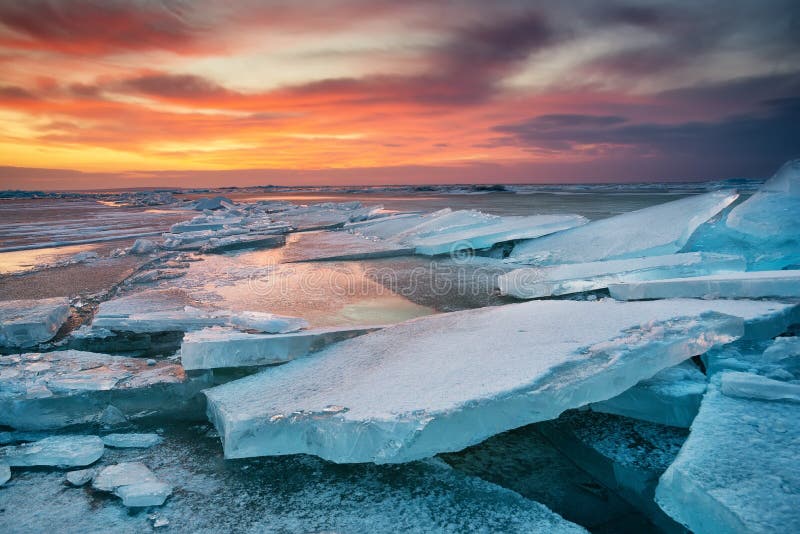 Vinterlandskap på kusten under solnedgång Lofoten öar, Norge Is och solnedgånghimmel royaltyfri bild