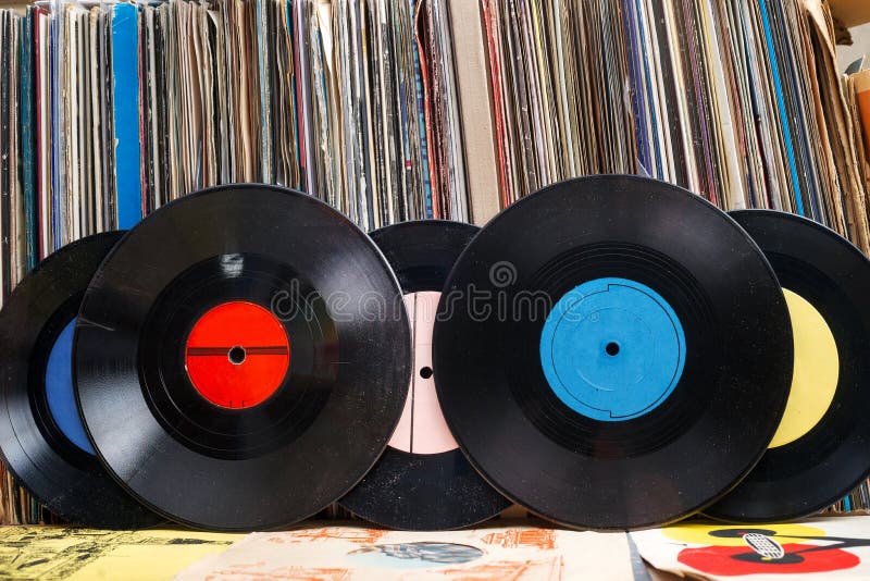 Vinyl record with copy space in front of a collection albums dummy titles, vintage process