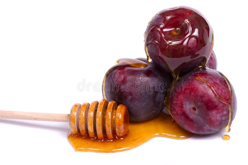 Violet plums with honey dipper