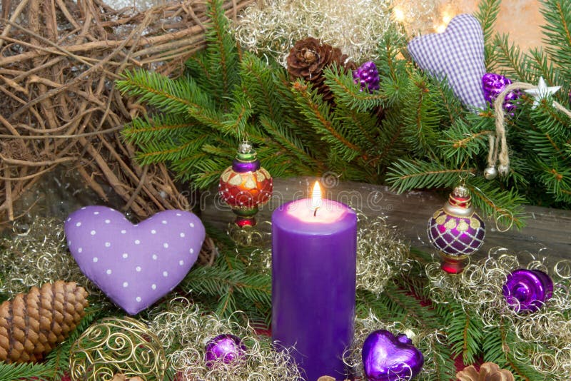 Violet or purple christmas decoration with a candle and a red do