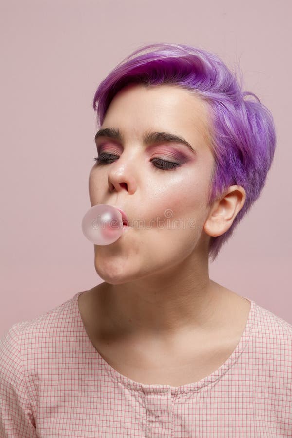 Violet Short Haired Girl In Pink Pastel Blowing Pink Bubble Gum Stock