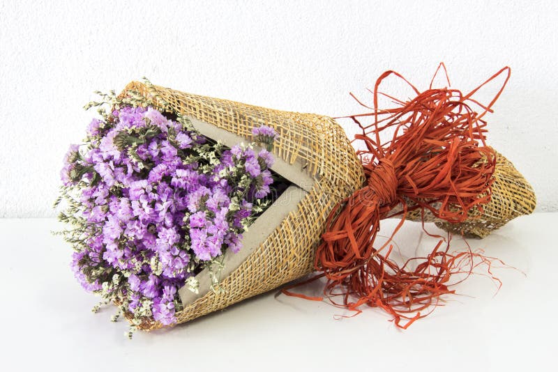 Violet Statice Flower Bouquet On White Cement Wall And White Table