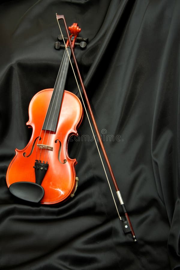Violin and bow on black silk