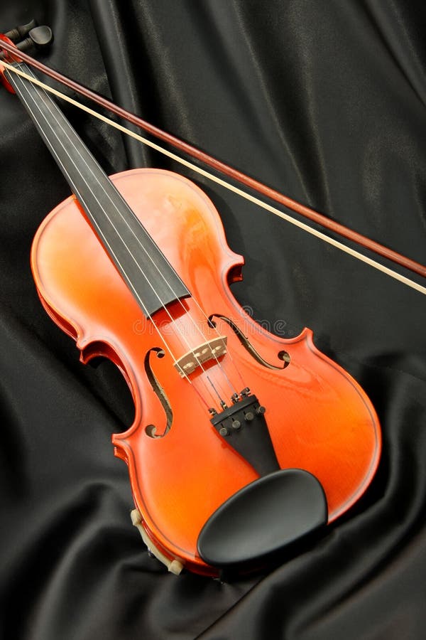 Violin and bow on black silk