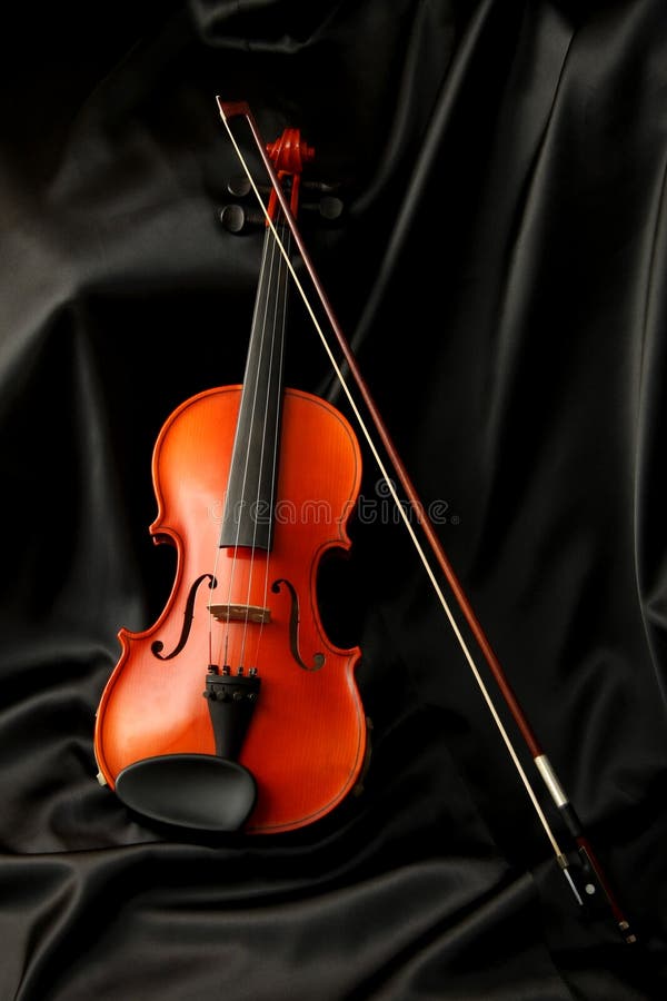 Violin and bow on black silk