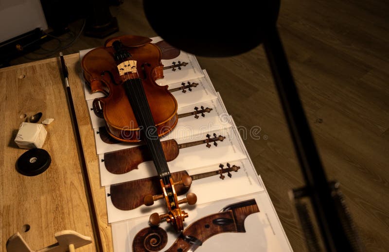 Violin and Bow with Instrument Diagrams on Worktable Stock Photo ...