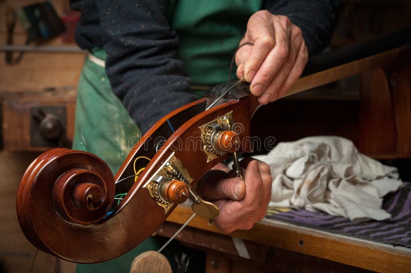 Rack of Violins Awaiting Work in Violin Repair Shop. Stock Photo Image of styles, restoration