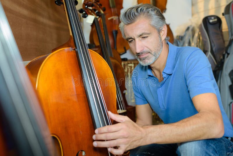 Violin Maker while Testing Violins in Stock Image Image of