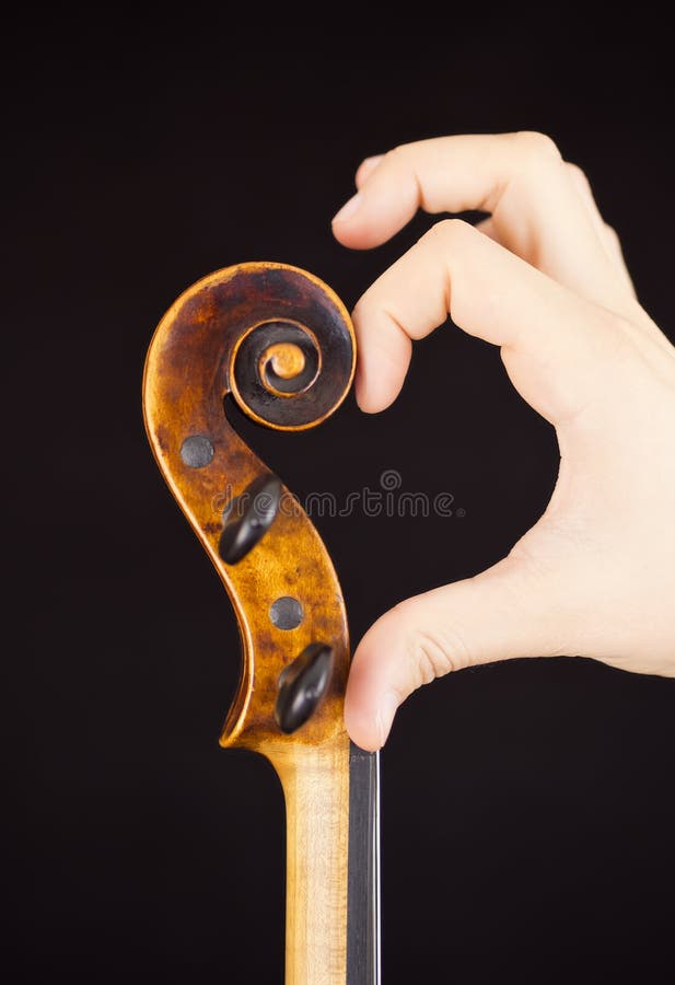Violin peg box (Violin and hand forming a heart) stock photos
