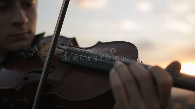 Violin. Violinist playing at sunset. Strings violin and bow.