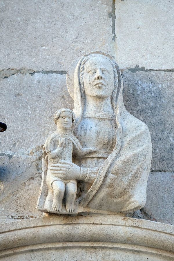 Statue of Virgin Mary with baby Jesus on the St Mark s Cathedral in the historic city Korcula at the island Korcula in Croatia. Statue of Virgin Mary with baby Jesus on the St Mark s Cathedral in the historic city Korcula at the island Korcula in Croatia