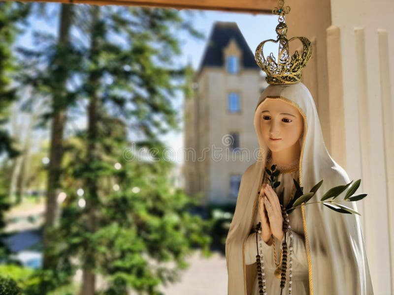 Mother Mary statue praying with her hands joined ,with a crown. Our Lady of Fatima. Paray-le-Monial, France.