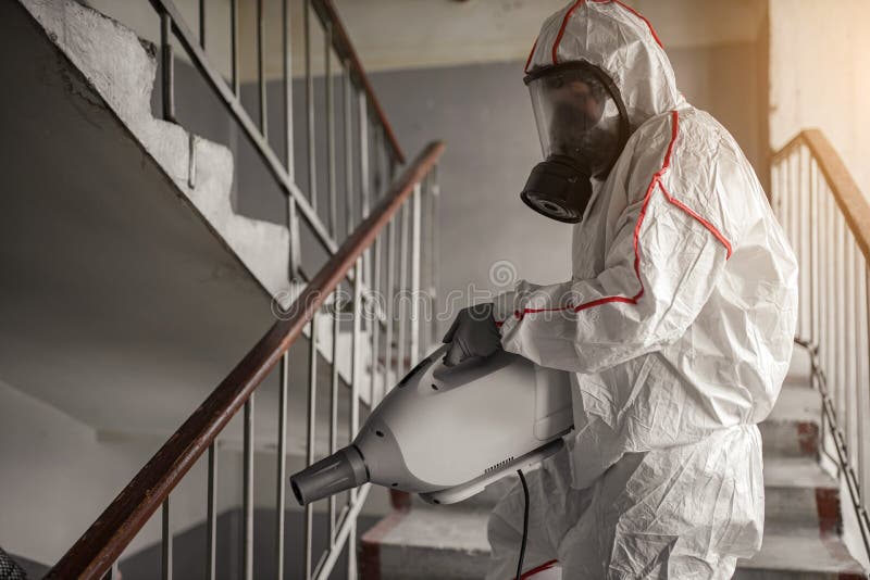 Virologist in protective hazmat suit conducts disinfections of surfaces in public and  places, pandemic health risk, coronavirus covid-19 concept. Virologist in protective hazmat suit conducts disinfections of surfaces in public and  places, pandemic health risk, coronavirus covid-19 concept