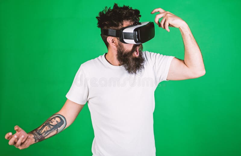 Virtual party concept. Hipster on shouting face having fun in virtual reality. Guy with head mounted display dance in stock photo Virtual party concept. Hipster on shouting face having fun in virtual reality. Guy with head mounted display dance in stock photo