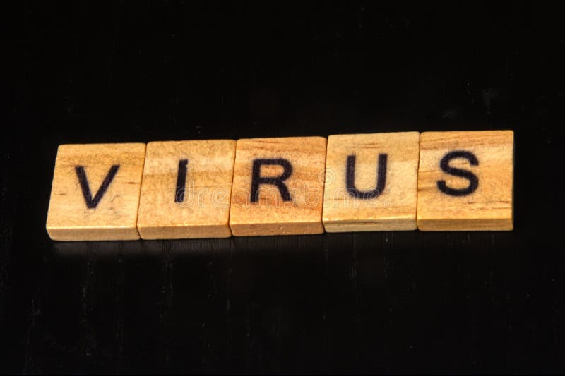 Close up photo of the word virus on wood squares