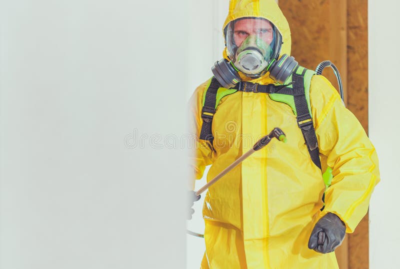 Disinfection For Virus Killing. Worker in Hazmat Suit and Face Protection Mask Spraying  Interior Using Chemical Agents To Stop Spreading Virus Infections. Disinfection For Virus Killing. Worker in Hazmat Suit and Face Protection Mask Spraying  Interior Using Chemical Agents To Stop Spreading Virus Infections