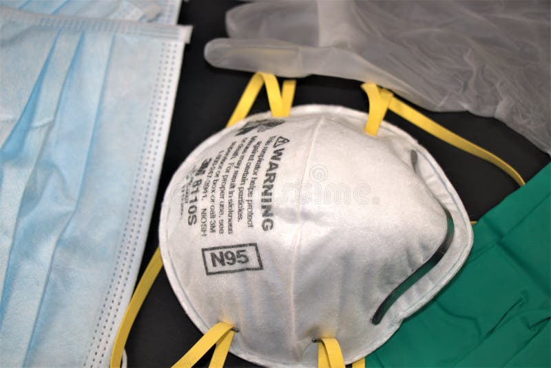 N95 respirator and surgical gloves on black background. Use as PPE or Personal Protective Equipment or PPE. N95 respirator and surgical gloves on black background. Use as PPE or Personal Protective Equipment or PPE.