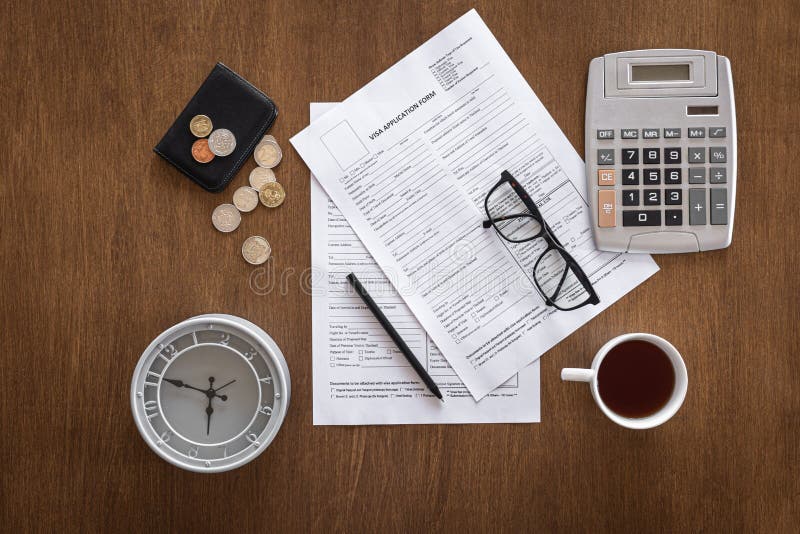 visa-application-form-on-a-wooden-table-visa-processing-registration-flat-lay-stock-photo