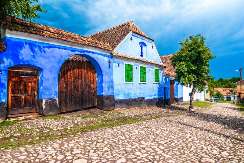 Viscri, Brasov, Roumanie : Maison traditionnelle peinte par bleu de force photos stock Viscri, Brasov, Roumanie : Maison traditionnelle peinte par bleu de force photos stock