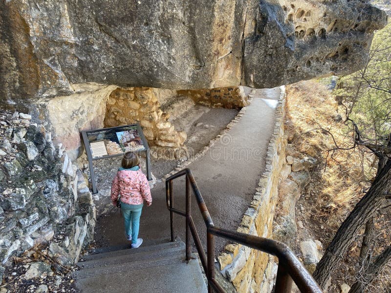 Walnut Canyon, Arizona, United States - February 1st, 2024: Visitors exploring the pre Colombian cave dwellings in the limestone cliffs of Walnut Canyon, used by the Sinaguan people, in Arizona, USA. Walnut Canyon, Arizona, United States - February 1st, 2024: Visitors exploring the pre Colombian cave dwellings in the limestone cliffs of Walnut Canyon, used by the Sinaguan people, in Arizona, USA.