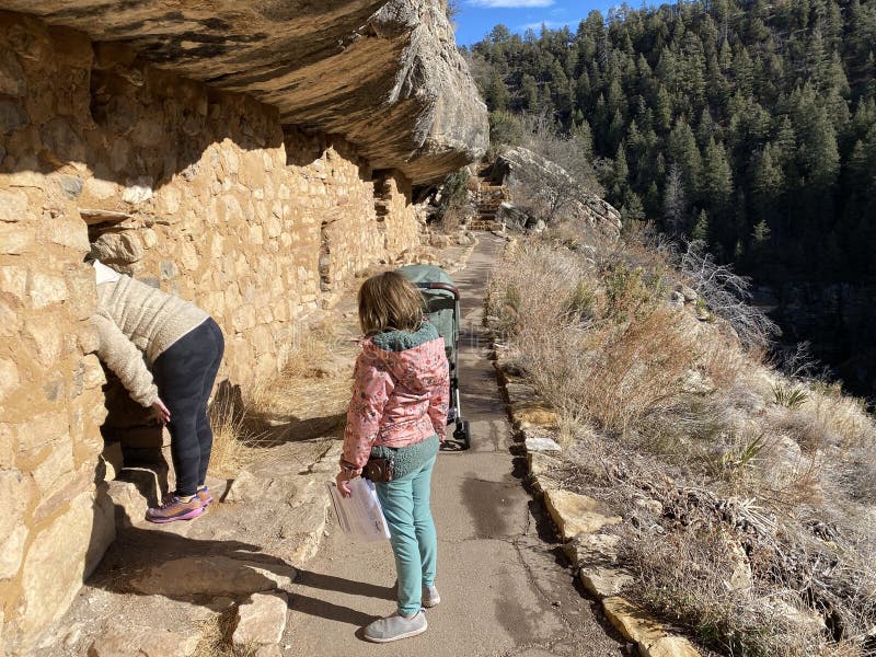 Walnut Canyon, Arizona, United States - February 1st, 2024: Visitors exploring the pre Colombian cave dwellings in the limestone cliffs of Walnut Canyon, used by the Sinaguan people, in Arizona, USA. Walnut Canyon, Arizona, United States - February 1st, 2024: Visitors exploring the pre Colombian cave dwellings in the limestone cliffs of Walnut Canyon, used by the Sinaguan people, in Arizona, USA.
