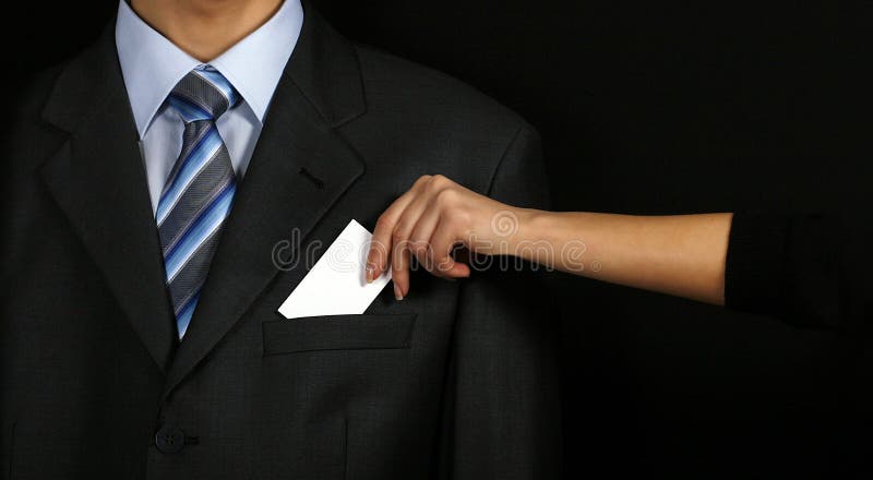 Businesswomen holding a card near man in suit. Businesswomen holding a card near man in suit