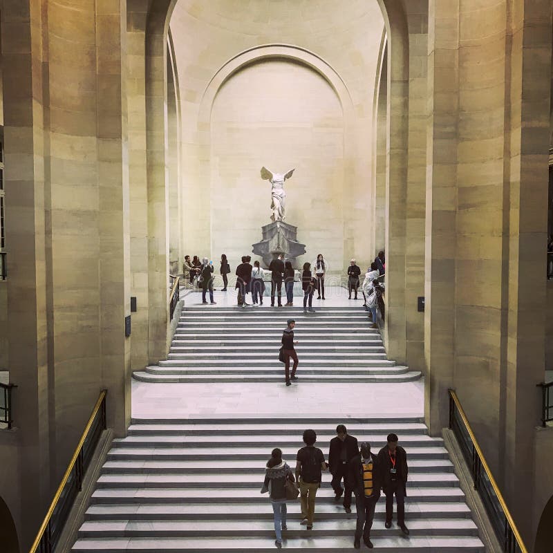 Nov 3, 2017: Visitors approach the Winged Victory at the top of the Grand Staircase in the Louvre, Paris, France. Nov 3, 2017: Visitors approach the Winged Victory at the top of the Grand Staircase in the Louvre, Paris, France