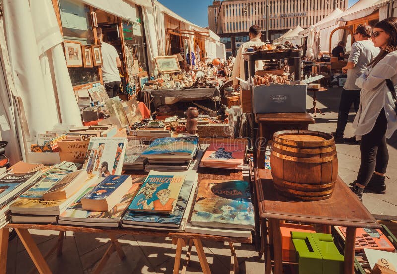 Visitors looking old books at flea market outdoor with retro toys, utensils, second hand staff. FLORENCE, ITALY - SEPT 25: Visitors looking old books at flea stock image Visitors looking old books at flea market outdoor with retro toys, utensils, second hand staff. FLORENCE, ITALY - SEPT 25: Visitors looking old books at flea stock image