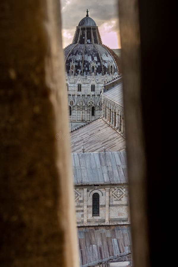 Ascending the Leaning Tower of Pisa, Tuscany, Italy: a glimpse of the Duomo of Pisa, on Piazza dei Miracoli. Ascending the Leaning Tower of Pisa, Tuscany, Italy: a glimpse of the Duomo of Pisa, on Piazza dei Miracoli