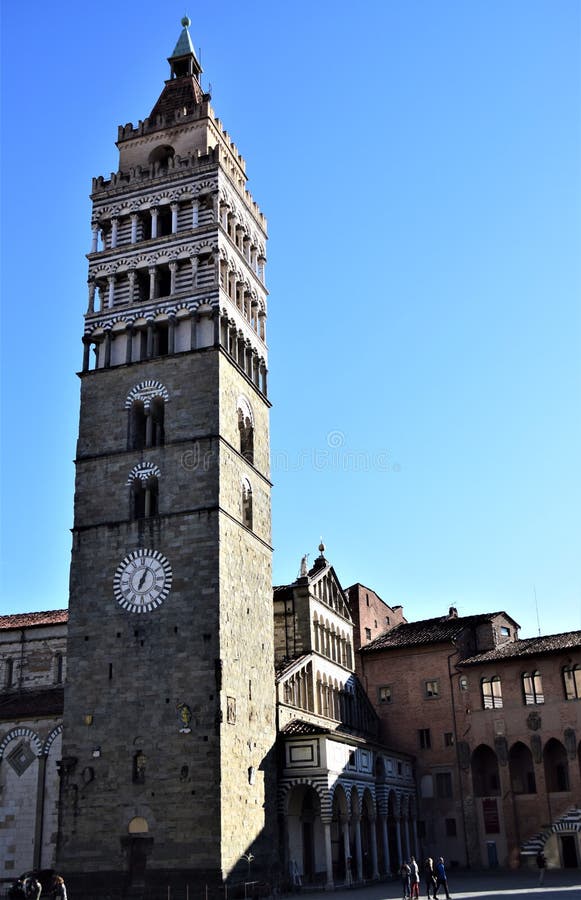 Glimpse of the main square of the city with the bell tower in the foreground that stands in the blue sky in Pistoia near the city center. Pistoia is a city in Tuscany. Around its central Piazza del Duomo are the Cathedral of San Zeno, the octagonal Baptistery of San Giovanni in corte and the Palazzo dei Vescovi. Glimpse of the main square of the city with the bell tower in the foreground that stands in the blue sky in Pistoia near the city center. Pistoia is a city in Tuscany. Around its central Piazza del Duomo are the Cathedral of San Zeno, the octagonal Baptistery of San Giovanni in corte and the Palazzo dei Vescovi.