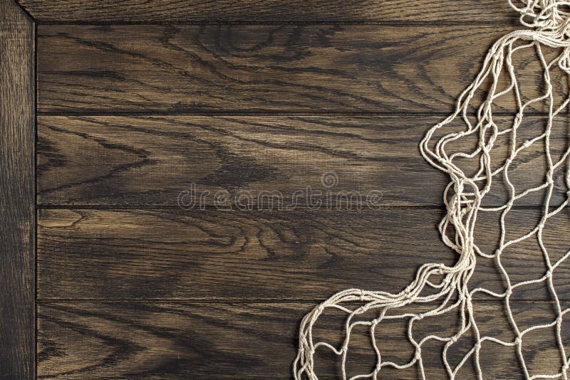 Fishing net on old oak board background with copy space. Fishing net on old oak board background with copy space