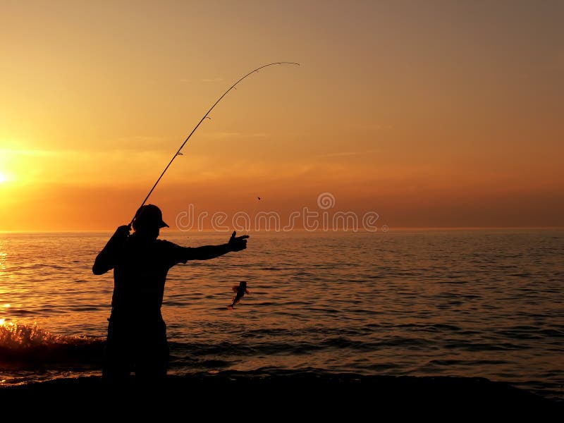 A person catching fish. Photo taken at Gros Morne National Park (Canada), and the body of water is the Atlantic Ocean. A person catching fish. Photo taken at Gros Morne National Park (Canada), and the body of water is the Atlantic Ocean.