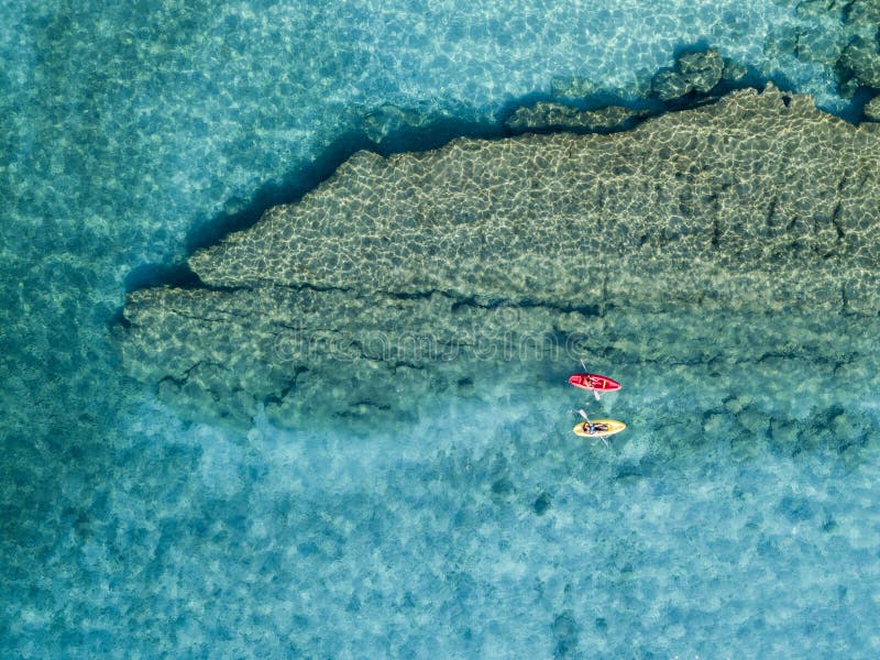 Vista aerea di una canoa nell'acqua che galleggia su un mare trasparente Bagnanti in mare Zambrone, Calabria, Italia