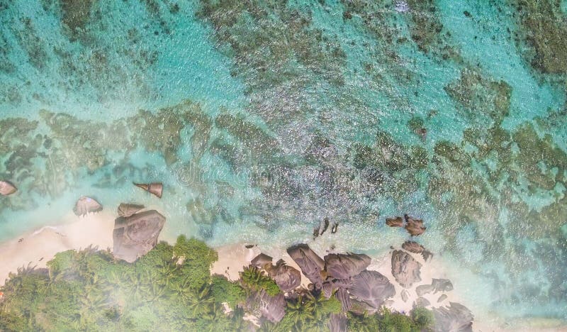 Overhead aerial view of Anse Source Argent Beach in La Digue, Seychelle Islands - Africa. Overhead aerial view of Anse Source Argent Beach in La Digue, Seychelle Islands - Africa