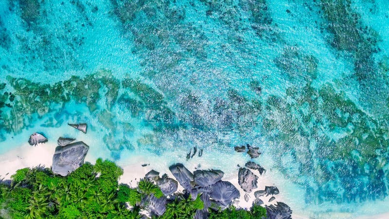 Overhead aerial view of Anse Source Argent Beach in La Digue, Seychelle Islands - Africa. Overhead aerial view of Anse Source Argent Beach in La Digue, Seychelle Islands - Africa