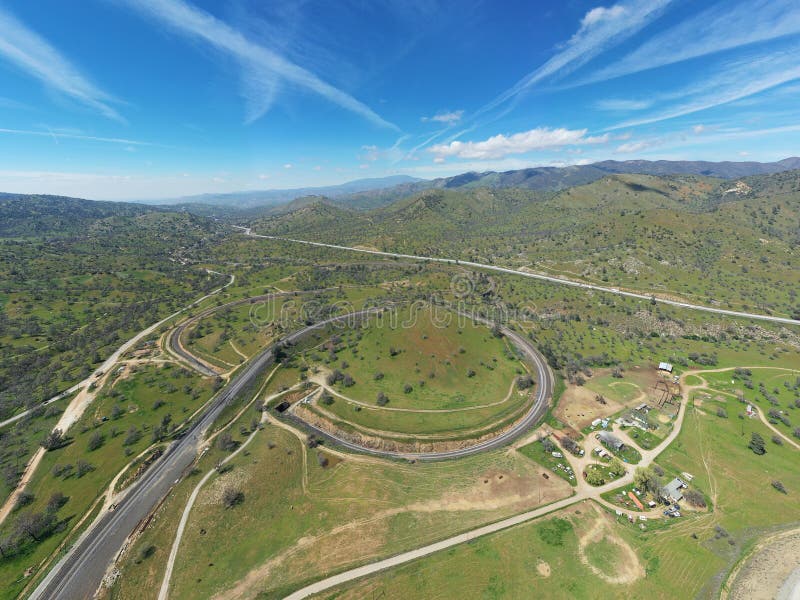 Aerial view of a winding rural dirt road in a valley. Aerial view of a winding rural dirt road in a valley