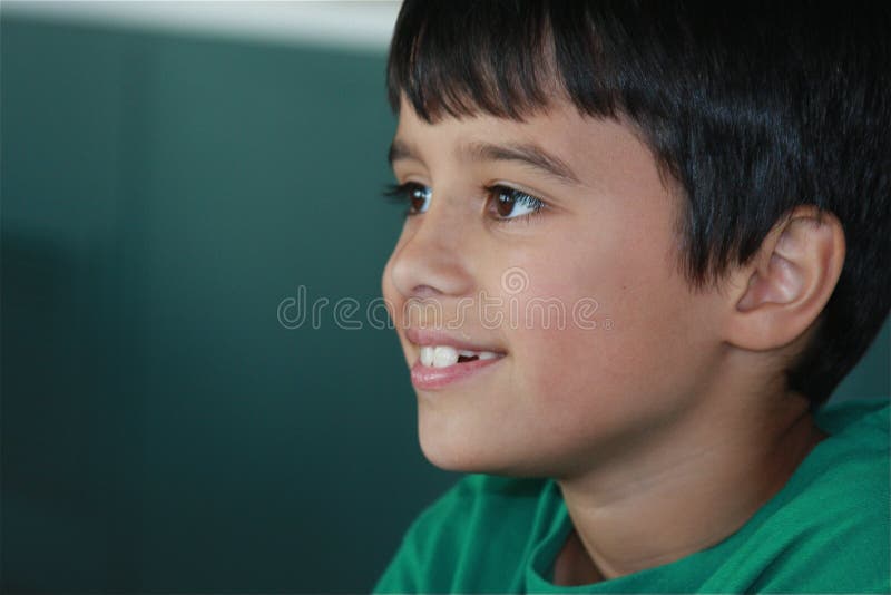 A cute child is looking to the left side with a hopeful expression on his face. A cute child is looking to the left side with a hopeful expression on his face.