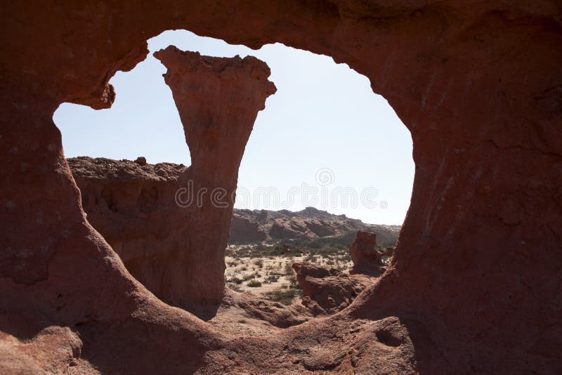 A view through a rock on the landscape of the Quebrada de Cafayate - Rio de las Conchas in Salta, Northern Argentina. A view through a rock on the landscape of the Quebrada de Cafayate - Rio de las Conchas in Salta, Northern Argentina.