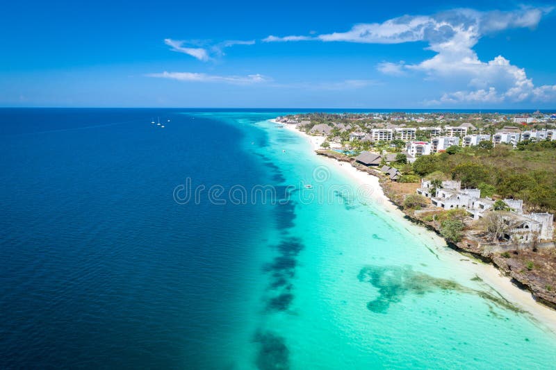 Aerial view of Nungwi beach in Zanzibar, Tanzania with luxury resort and turquoise ocean water. Toned image. Aerial view of Nungwi beach in Zanzibar, Tanzania with luxury resort and turquoise ocean water. Toned image