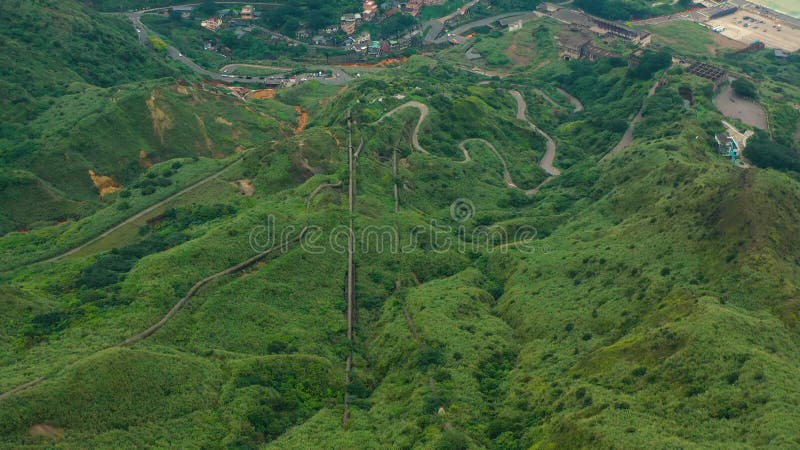 : vista aérea de exuberante vegetación y carreteras sinuosas en el terreno montañoso de taiwán metrajes
