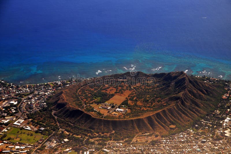 Rare Aerial view of Diamond Head extinct volcanic crater. Diamond Head is a volcanic tuff cone on the Hawaiian island of OÊ»ahu and known to Hawaiians as LÄ“Ê»ahi, most likely from lae `browridge, promontory` plus Ê»ahi `tuna` because the shape of the ridgeline resembles the shape of a tuna`s dorsal fin. Rare Aerial view of Diamond Head extinct volcanic crater. Diamond Head is a volcanic tuff cone on the Hawaiian island of OÊ»ahu and known to Hawaiians as LÄ“Ê»ahi, most likely from lae `browridge, promontory` plus Ê»ahi `tuna` because the shape of the ridgeline resembles the shape of a tuna`s dorsal fin.