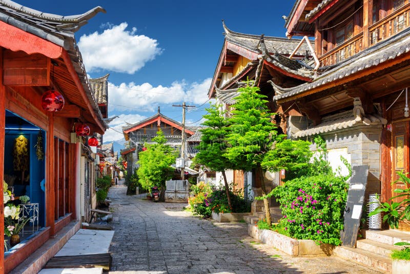 Scenic view of narrow street in the Old Town of Lijiang, Yunnan province, China. The Old Town of Lijiang is a popular tourist destination of Asia. Scenic view of narrow street in the Old Town of Lijiang, Yunnan province, China. The Old Town of Lijiang is a popular tourist destination of Asia.