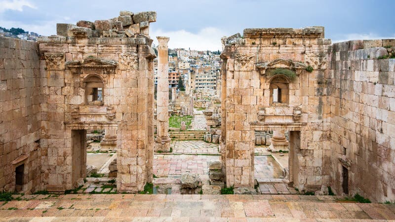 Travel to Middle East country Kingdom of Jordan - view of Jerash city through Gates of Artemis temple in ancient Gerasa town in winter. Travel to Middle East country Kingdom of Jordan - view of Jerash city through Gates of Artemis temple in ancient Gerasa town in winter