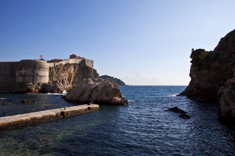 View of Dubrovnik`s walls and seanDubrovnik City Walls are a constellation of fortifications surrounding the old part of Dubrovnik.nnThey were built from the 13th to the 17th century for defense purposes. Long are 1940 m, up to 25 m high, on a land of 4-6 m in thickness, and by sea 1.5-3 m. On four sides of the world, they are protected by the towers.nnWhen the 13th century wall was built, the old town`s space was already defined and could no longer spread. Inside the city walls, around 2000 inhabitants lived in the Dubrovnik Republic at the time of the establishment of the Statute in 1272, and most of them were in the 15th century, about 6000 people [1]. In the 14th century 15 square-tower buildings were built. With the appearance of the pile, the ramparts have been strengthened to protect them from the artillery attacks. Because of the dangers of the Venetian, all unnecessary openings on the walls at the port are closed. City walls were given the present look in the 15th and 16th centuries. Wars affected the new construction. When Constantinople fell in 1453, the Minceta Tower was built. Because of the Turkish-Venetian wars, the towers of St. Ivan, Revelin and the Bastion of St. Margarete in St. Margaret`s. The walls were built at great speed because of the danger of war. View of Dubrovnik`s walls and seanDubrovnik City Walls are a constellation of fortifications surrounding the old part of Dubrovnik.nnThey were built from the 13th to the 17th century for defense purposes. Long are 1940 m, up to 25 m high, on a land of 4-6 m in thickness, and by sea 1.5-3 m. On four sides of the world, they are protected by the towers.nnWhen the 13th century wall was built, the old town`s space was already defined and could no longer spread. Inside the city walls, around 2000 inhabitants lived in the Dubrovnik Republic at the time of the establishment of the Statute in 1272, and most of them were in the 15th century, about 6000 people [1]. In the 14th century 15 square-tower buildings were built. With the appearance of the pile, the ramparts have been strengthened to protect them from the artillery attacks. Because of the dangers of the Venetian, all unnecessary openings on the walls at the port are closed. City walls were given the present look in the 15th and 16th centuries. Wars affected the new construction. When Constantinople fell in 1453, the Minceta Tower was built. Because of the Turkish-Venetian wars, the towers of St. Ivan, Revelin and the Bastion of St. Margarete in St. Margaret`s. The walls were built at great speed because of the danger of war